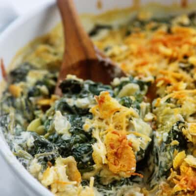 white baking dish full of spinach casserole.