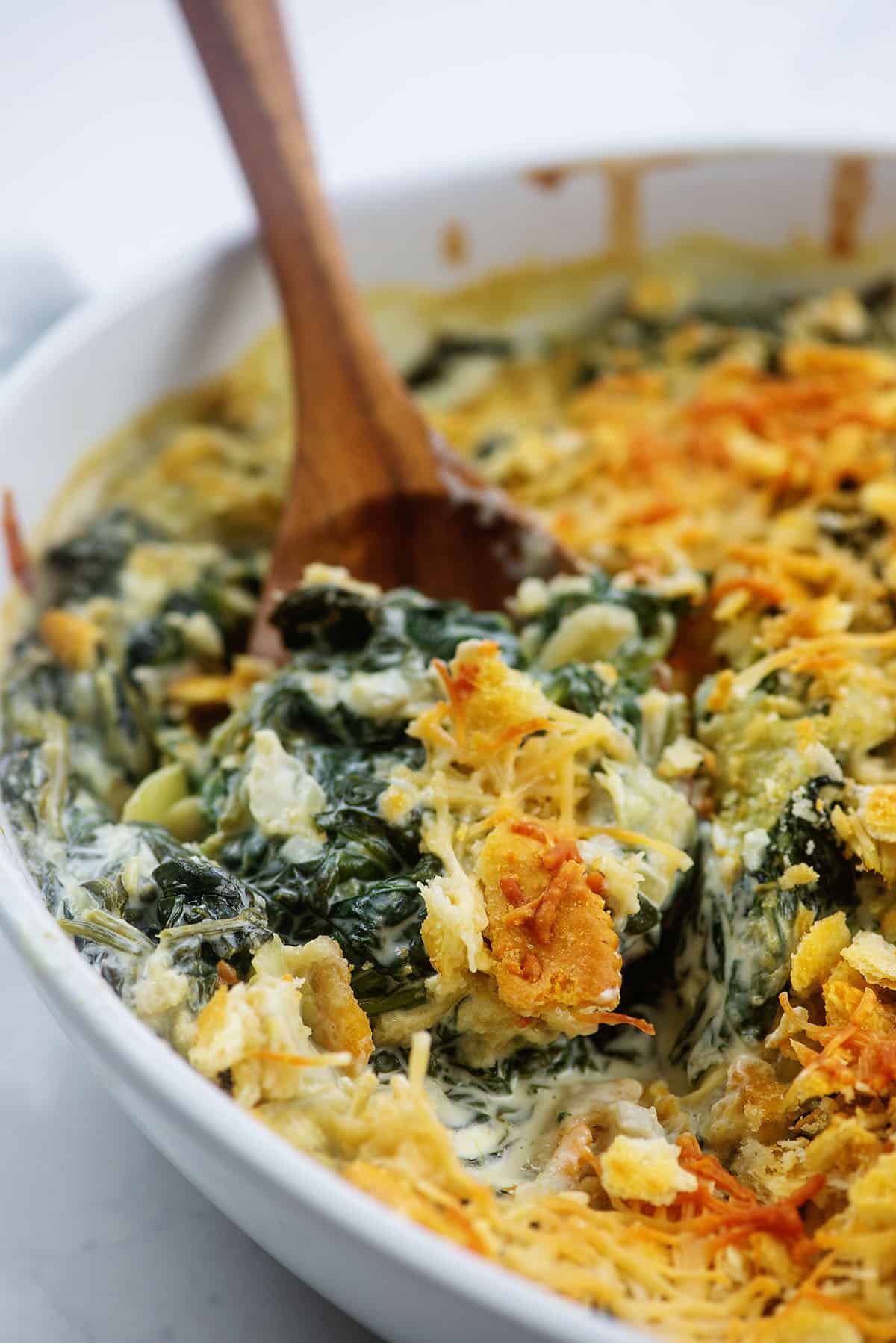 white baking dish full of spinach casserole.