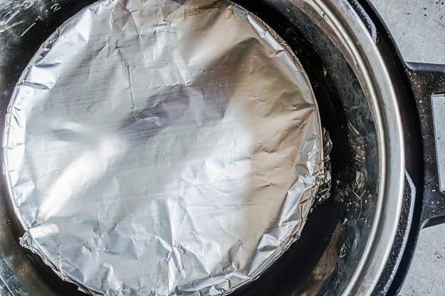overhead view of foil wrapped cheesecake in Instant Pot.