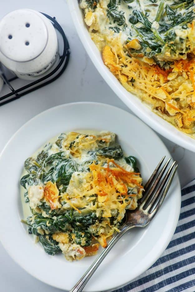 cheesy creamed spinach on white plate.