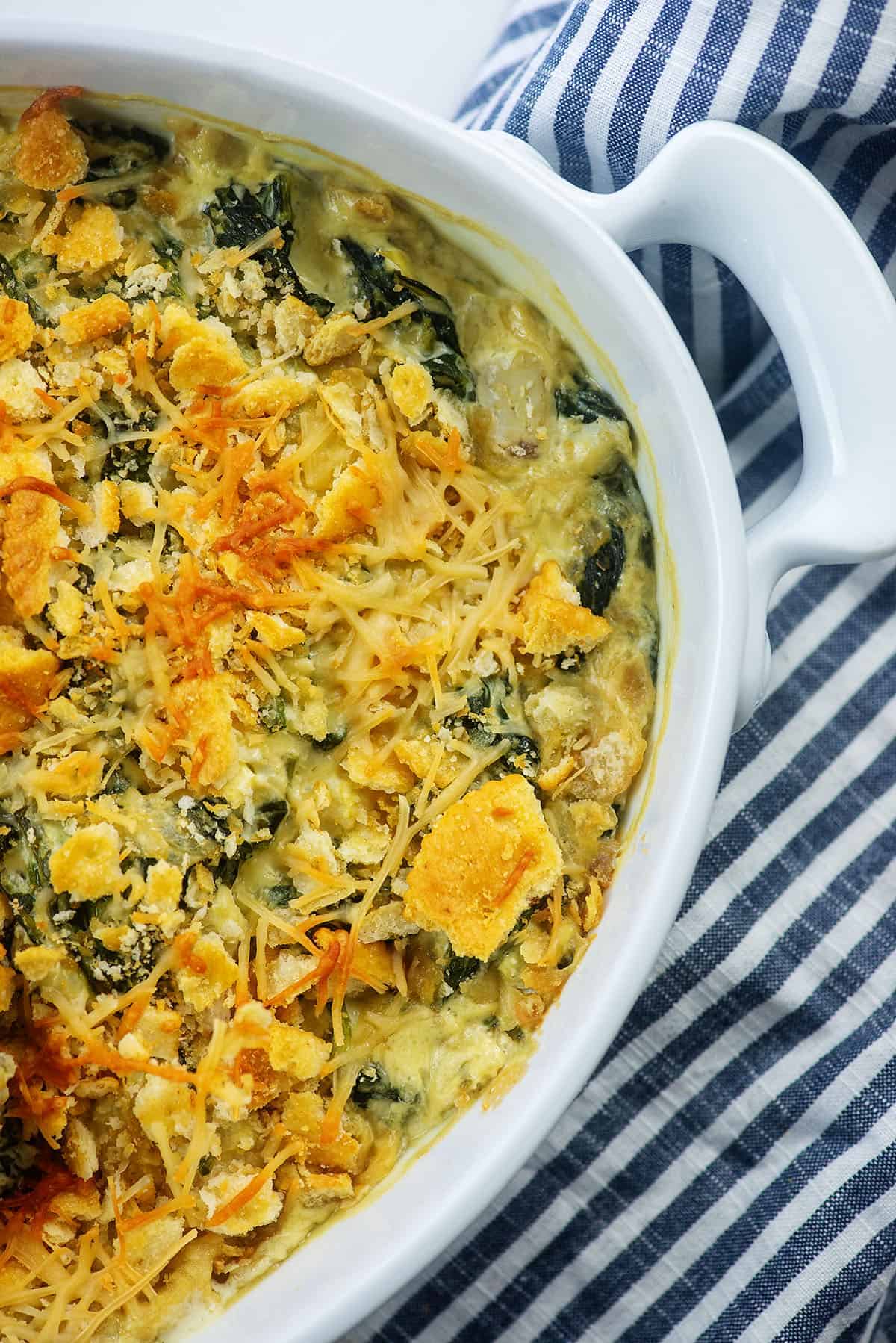 baked spinach casserole in white baking dish.