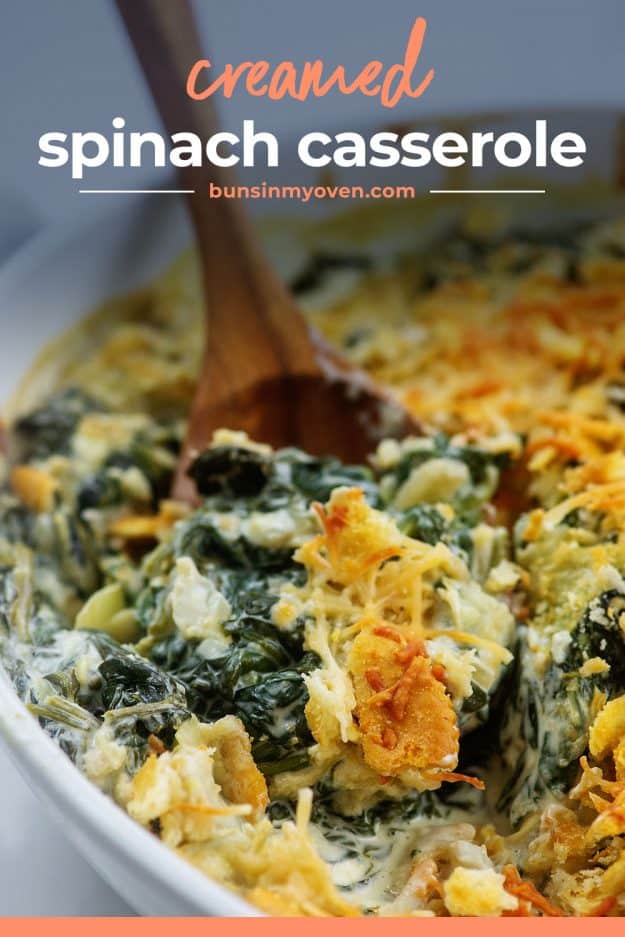 spinach casserole in dish with wooden spoon.