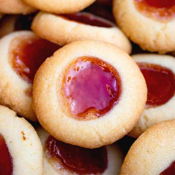 raspberry thumbprint cookies in a pile