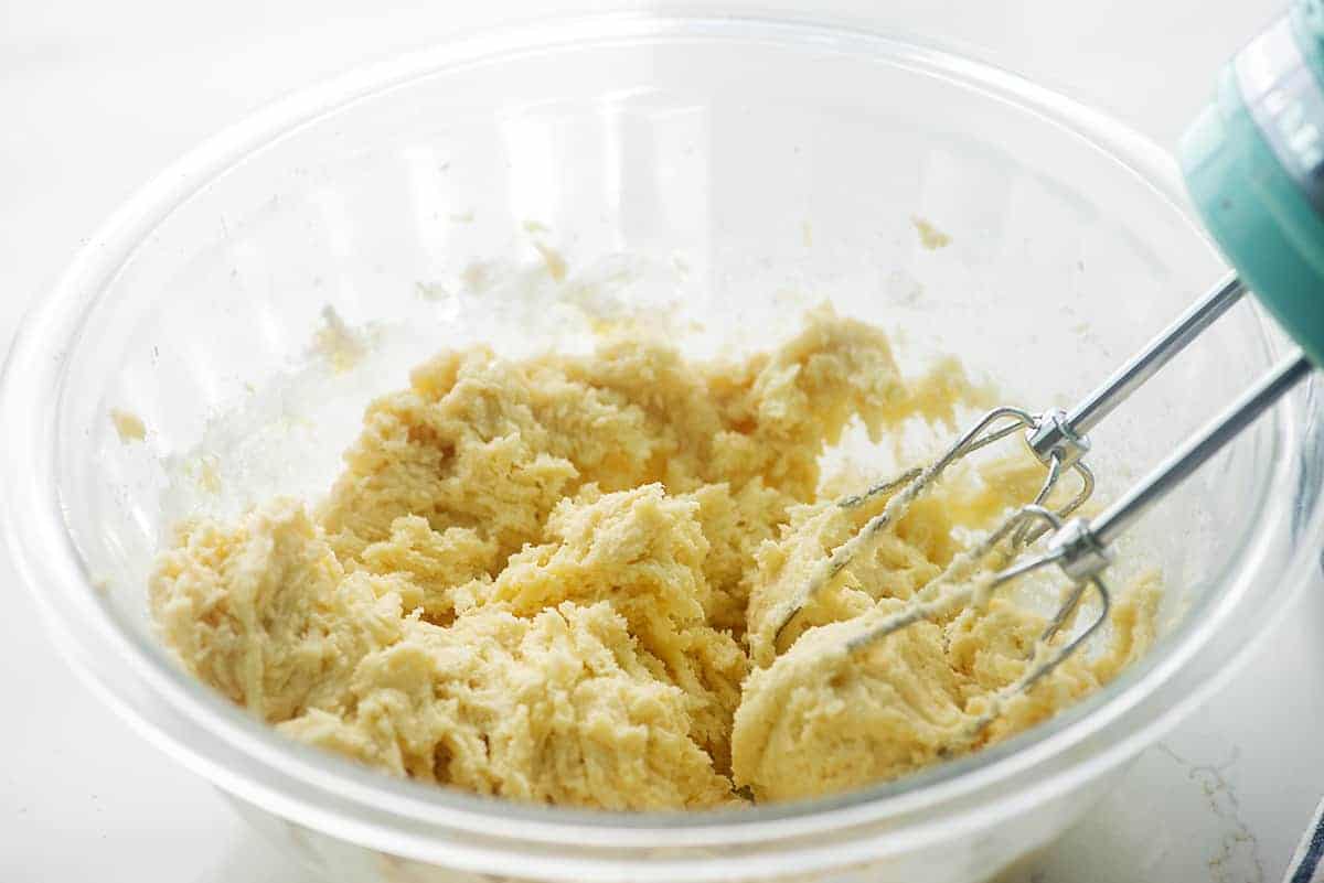 snickerdoodle cookie dough in glass mixing bowl.