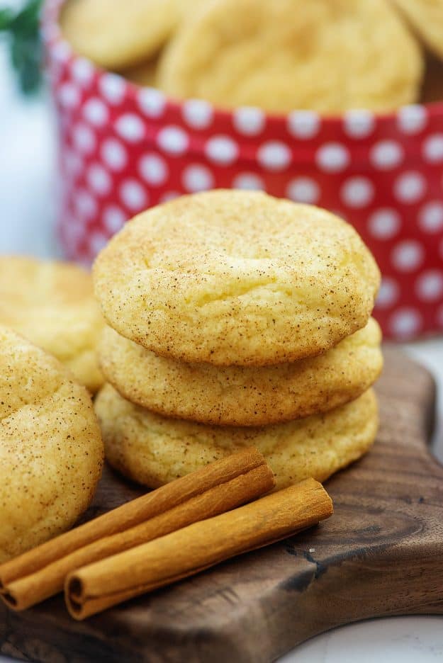 stack of thick snickerdoodle cookies on wooden board.