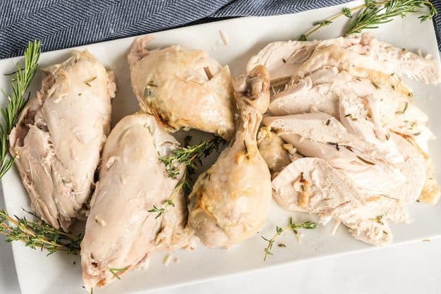 roasted chicken parts on white serving platter.