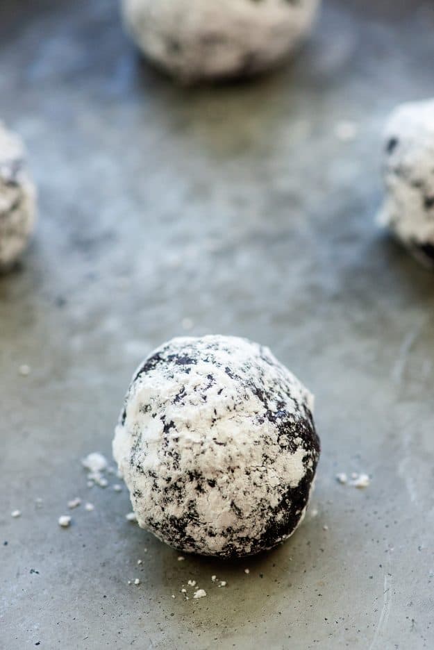 chocolate cookie dough ball rolled in powdered sugar.