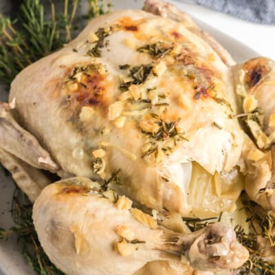 roasted chicken on a bed of herbs.