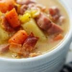 close up of ham and corn soup recipe in white bowl.