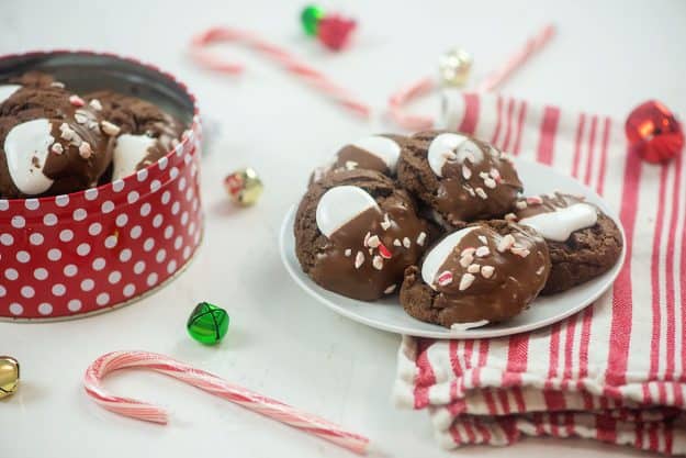 peppermint chocolate cookies on white plate surrounded by candy canes.