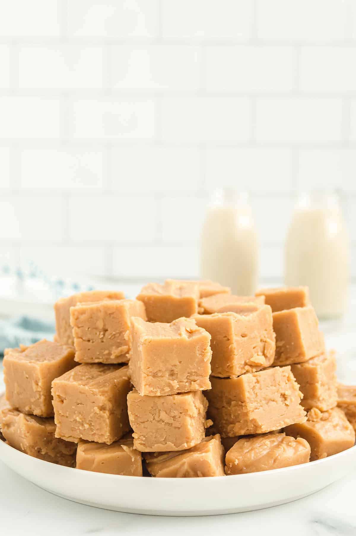 peanut butter fudge piled on white plate.