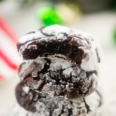 stack of chocolate cookies in front of Christmas decor.