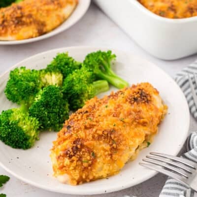 Baked ranch cheddar chicken on plate with broccoli.
