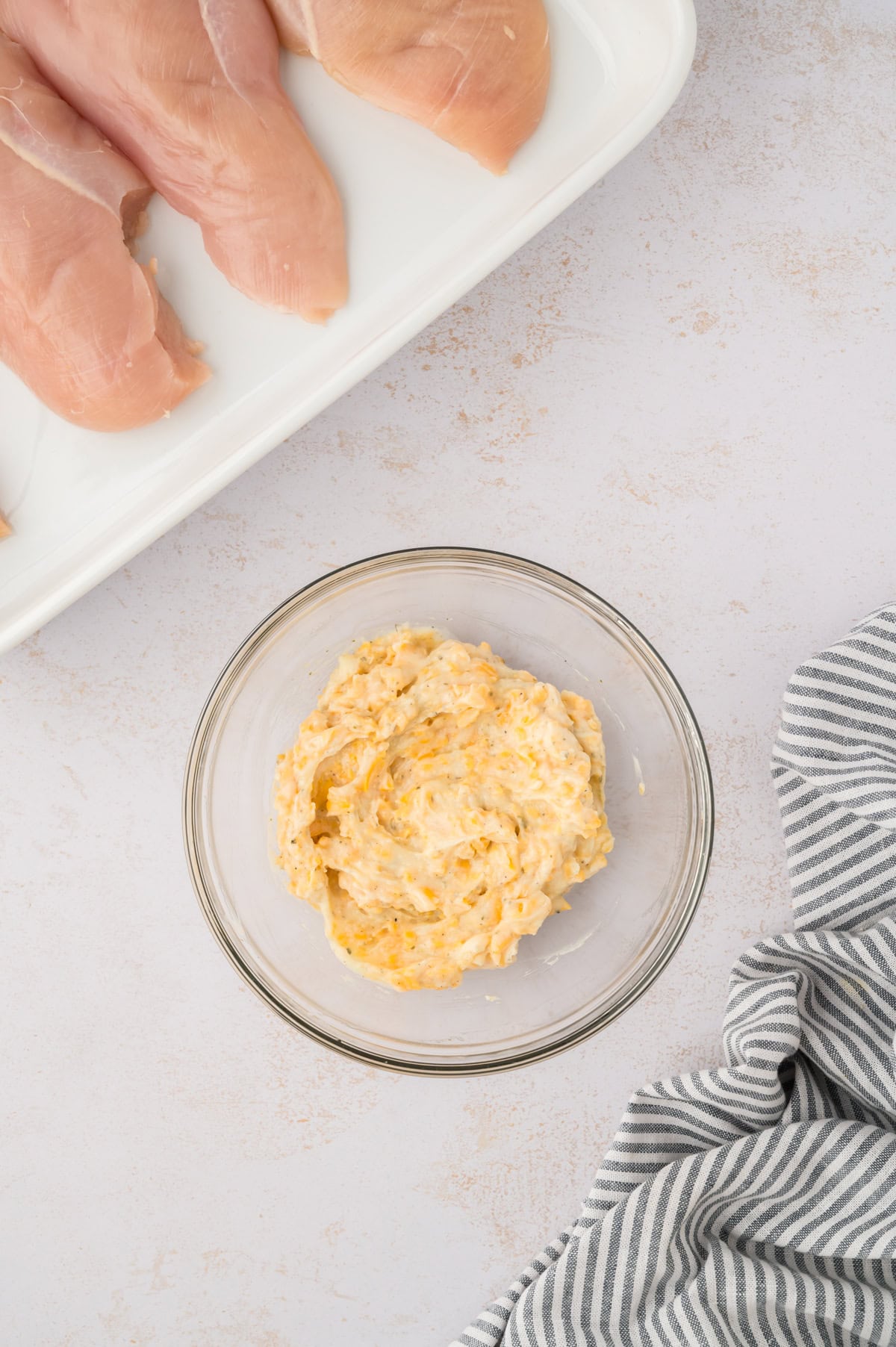 Mayo, ranch, and cheddar stirred together in small bowl.