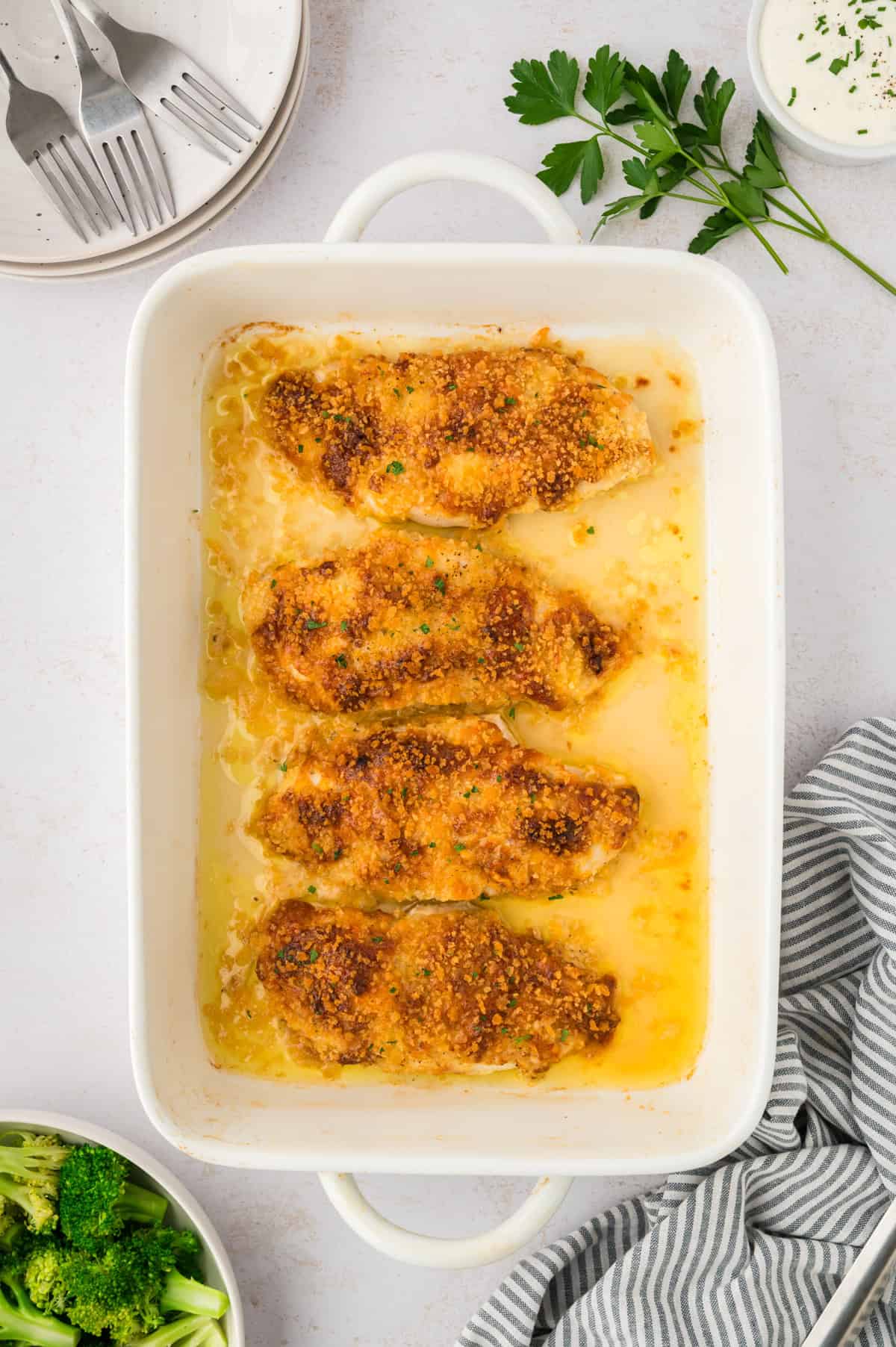 Baked ranch chicken in white baking dish.