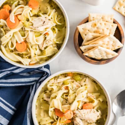 overhead view of chicken noodle soup in bowls.