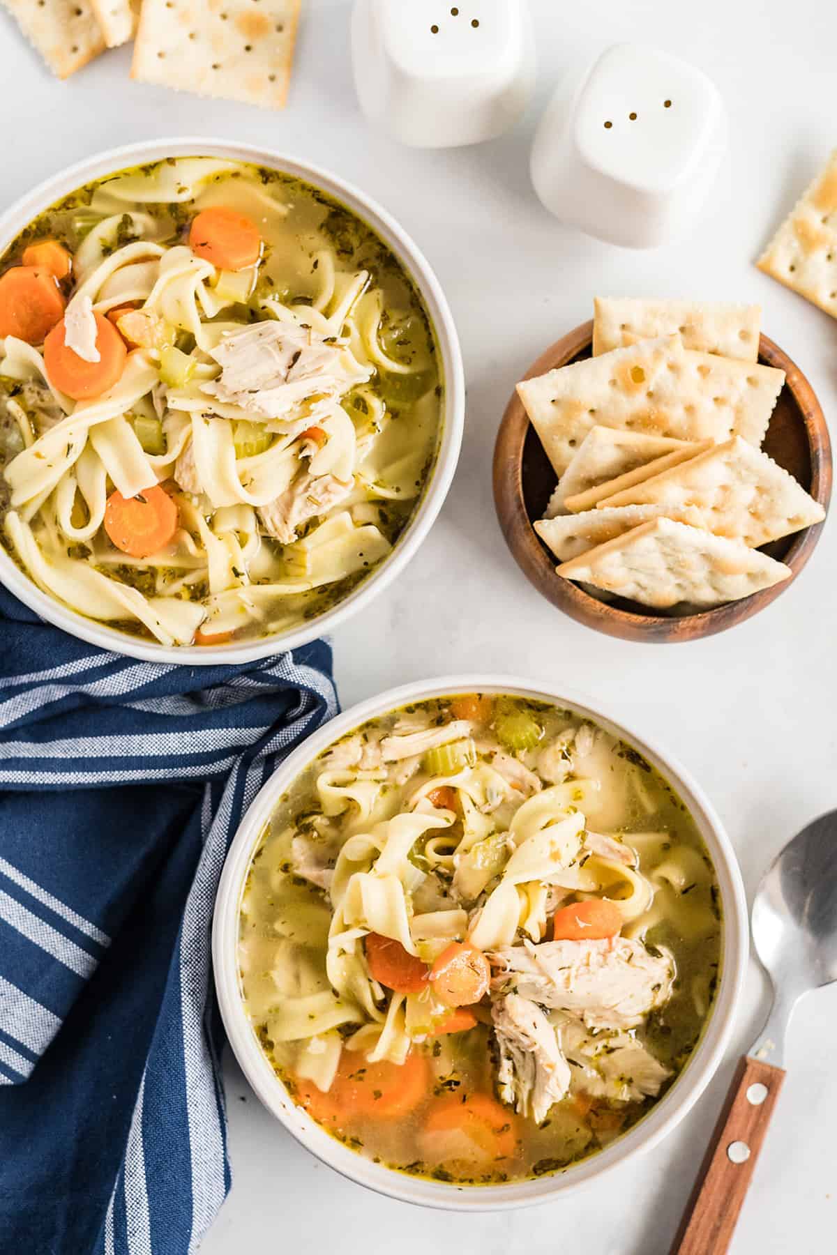 overhead view of chicken noodle soup in bowls.