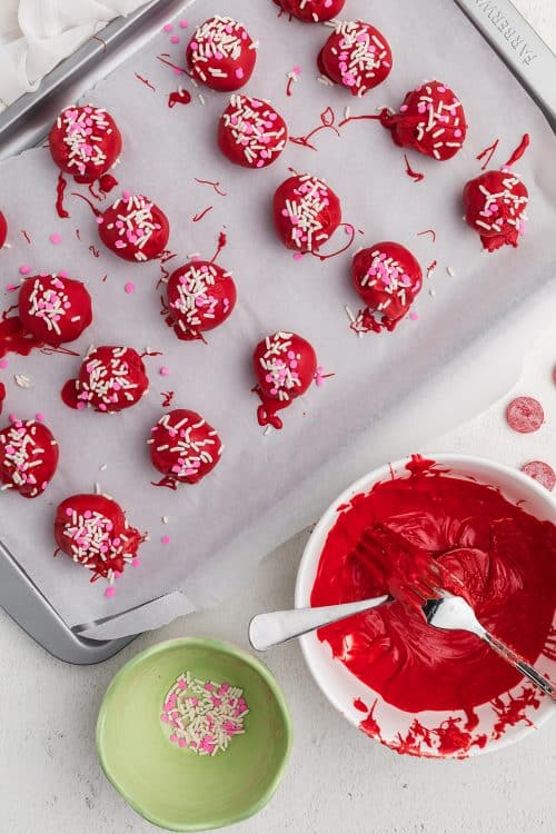 decorated cookie truffles on baking sheet.