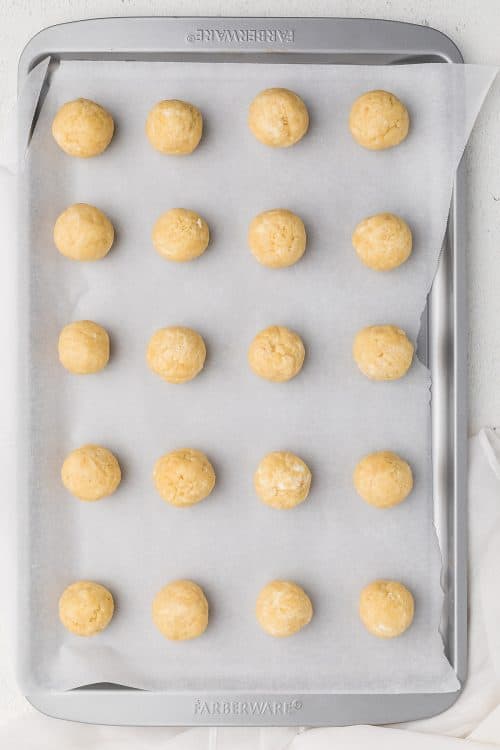 overhead view of cookie balls on baking sheet.