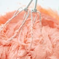 pink cake mix batter in glass bowl.