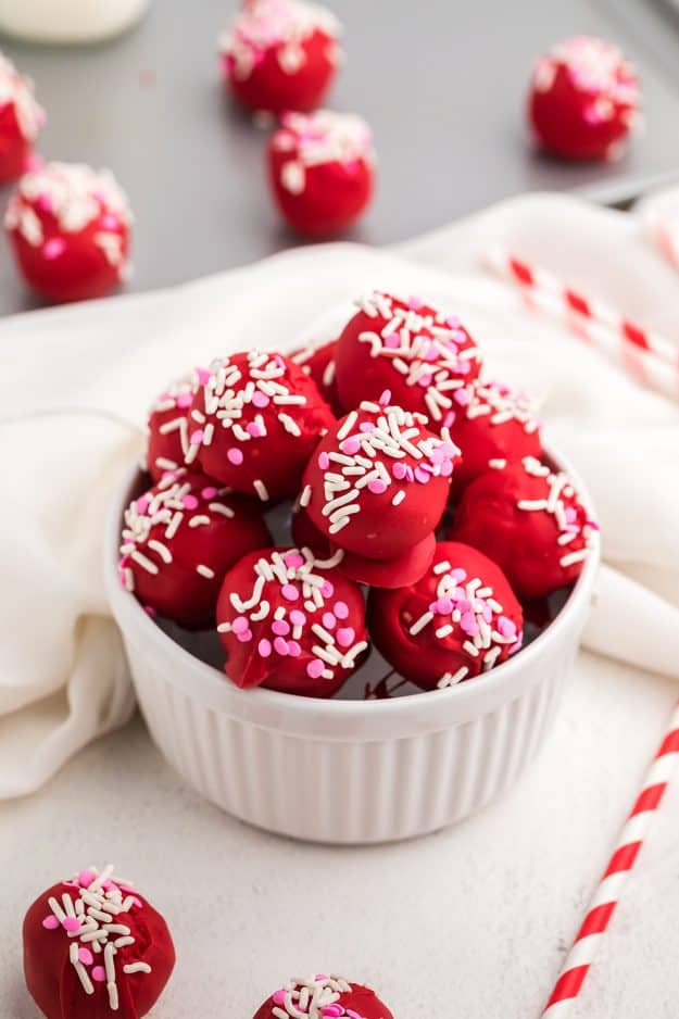 sugar cookie truffles in white bowl with sprinkles.