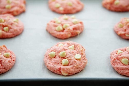 white chocolate strawberry cookies on baking sheet.