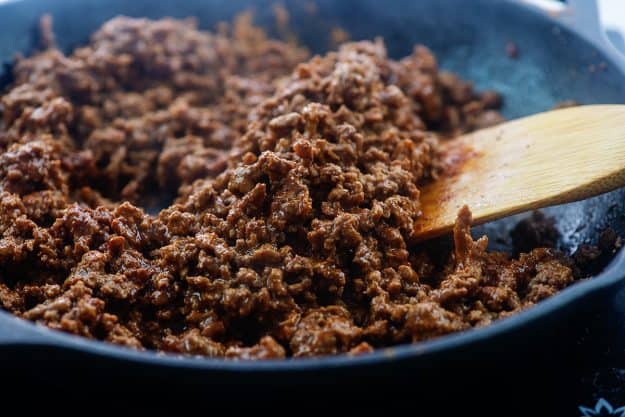 seasoned ground beef in cast iron skillet.