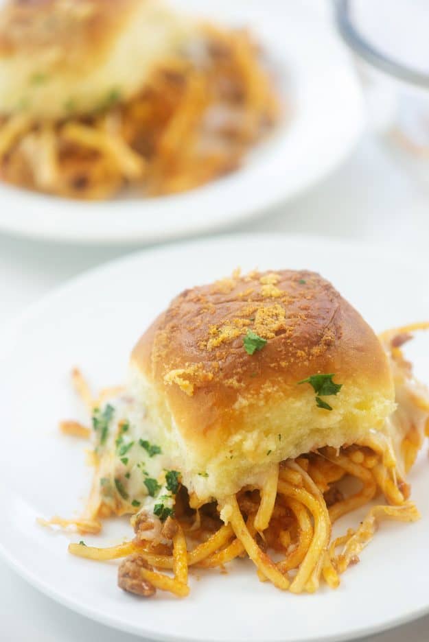 Spaghetti sandwich on white plate.