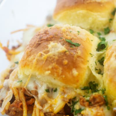 cheesy spaghetti sandwiches in glass baking dish.