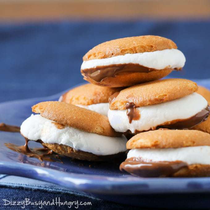 Close up side view of vanilla wafer microwave smores on a blue plate.