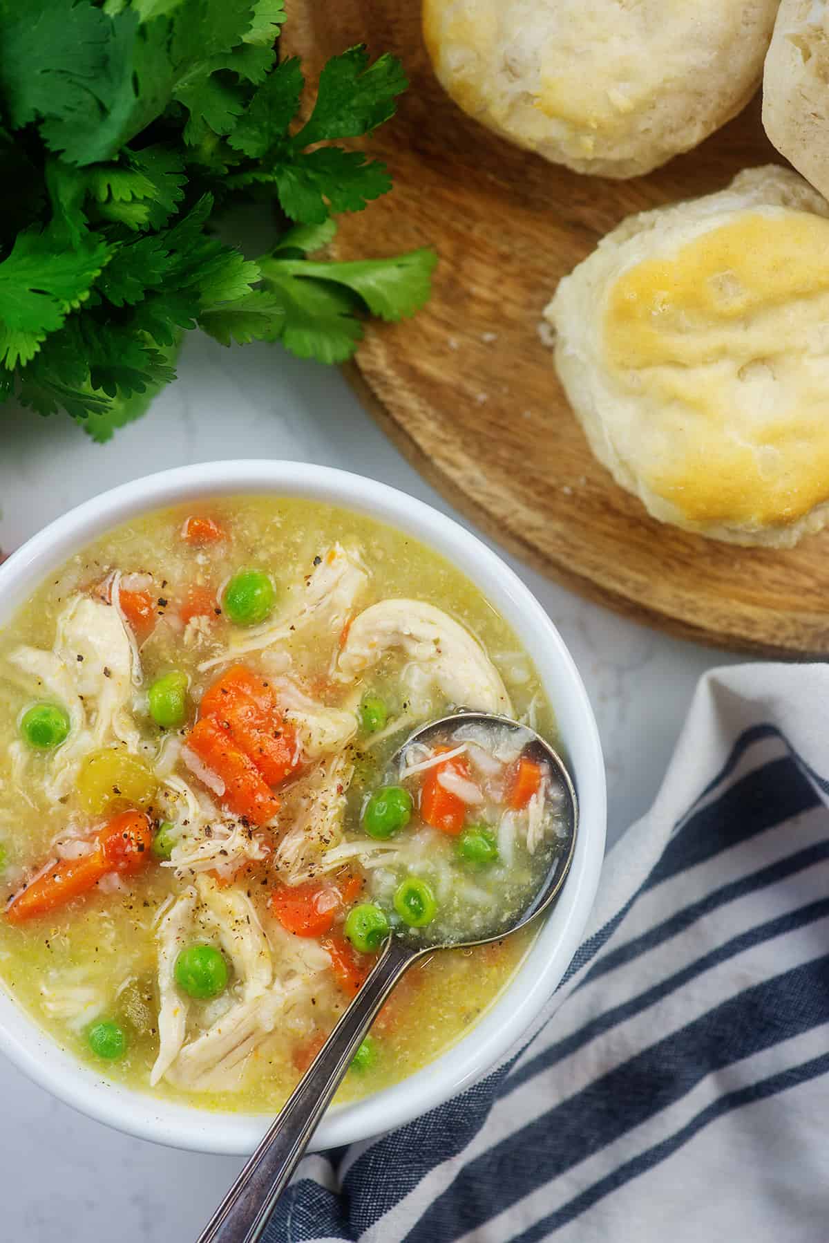 overhead view of chicken and rice soup in white bowl.