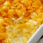 cheesy funeral potatoes in white baking dish.