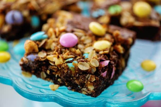 oatmeal topped brownies with Easter candy on cake stand.