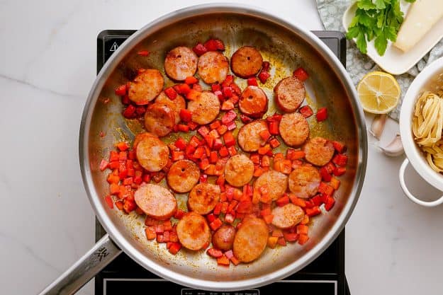 sausage and peppers in skillet.