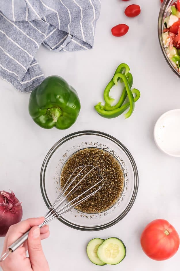 overhead view of salad dressing in glass bowl.