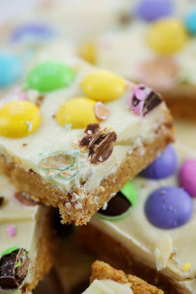 pile of no bake bars topped with Easter candy.