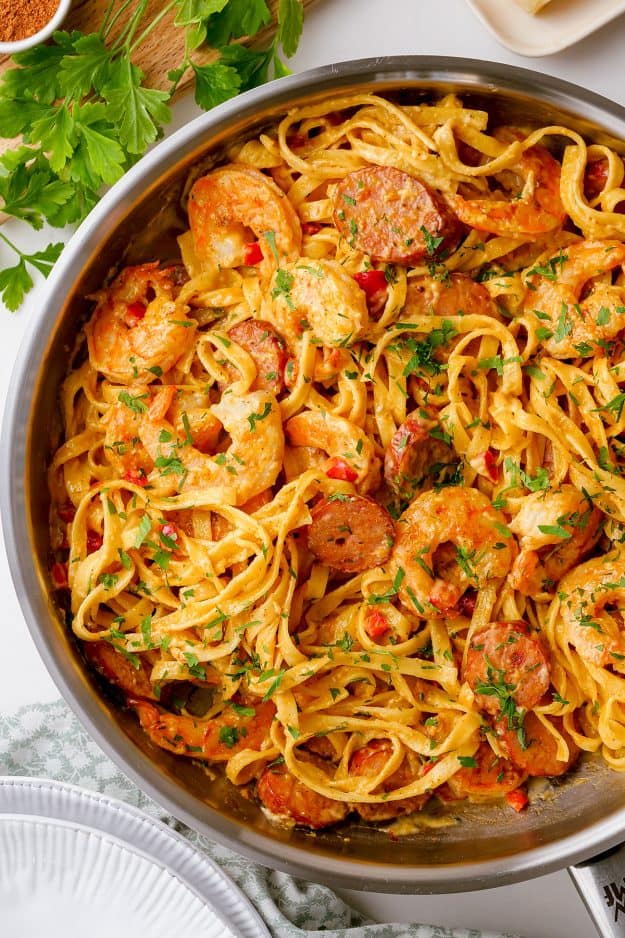 overhead view of cajun shrimp pasta in skillet.