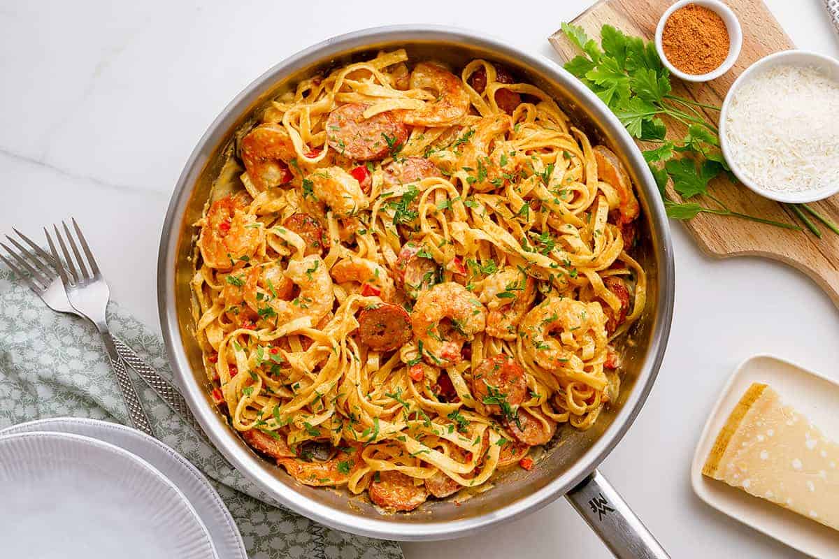 skillet full of cajun shrimp and sausage pasta.