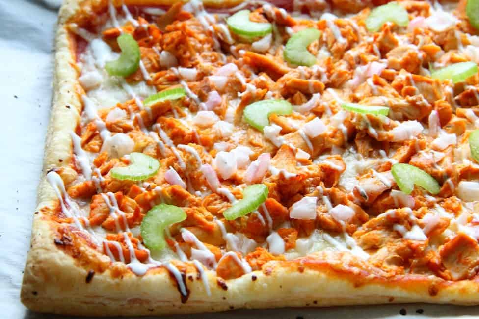 Close up view of a buffalo chicken puff pastry pizza.