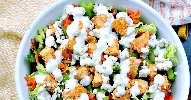 A top down view of buffalo chicken chopped salad in a white bowl.