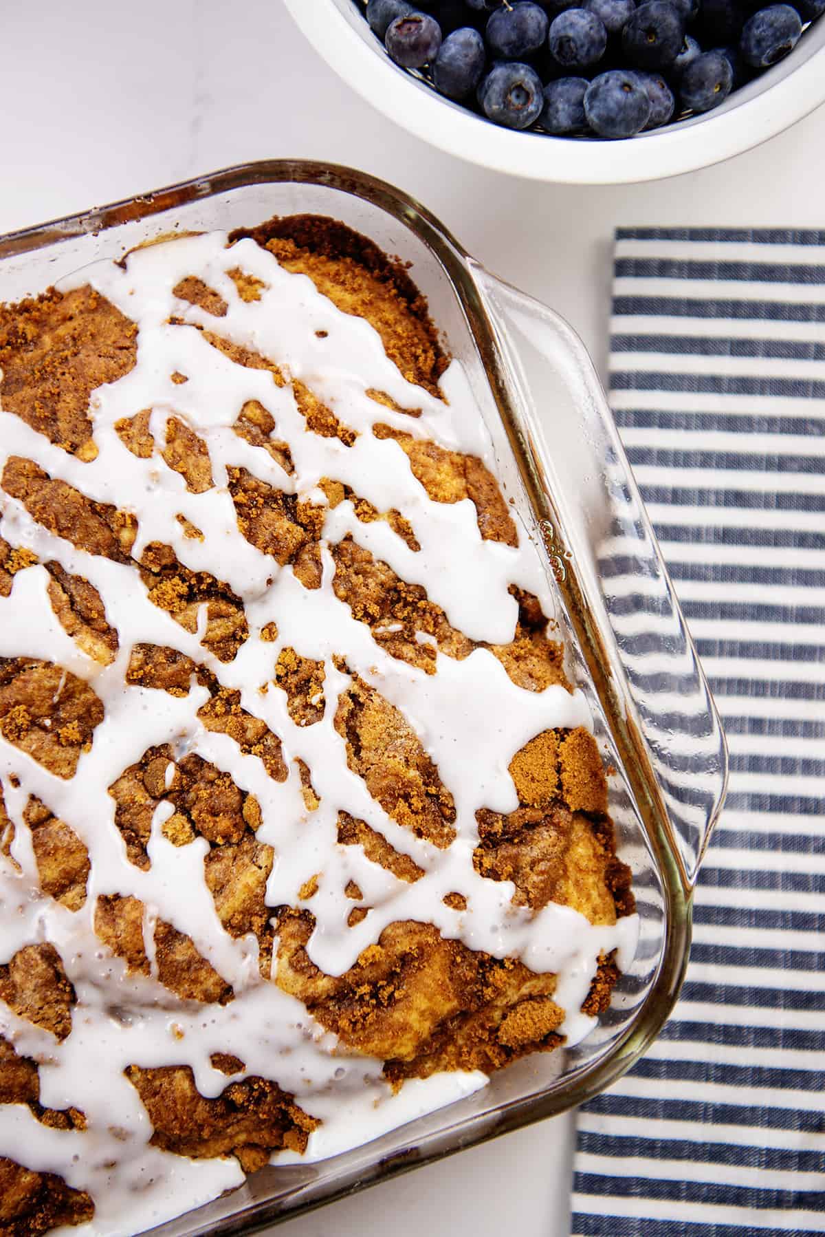 overhead view of blueberry cinnamon roll cake in glass baking dish.