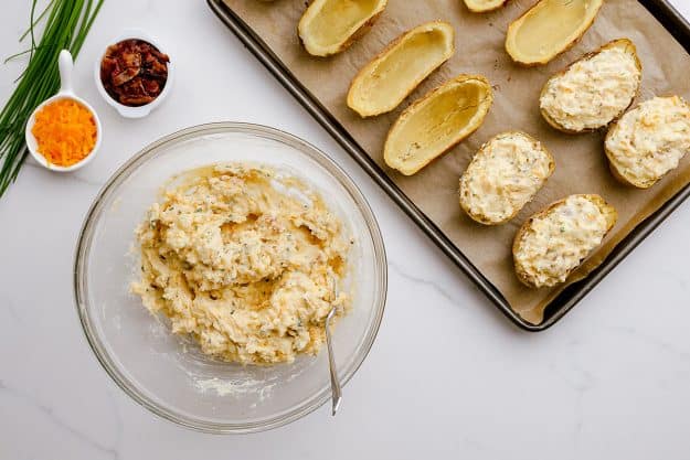 twice baked potatoes being filled.