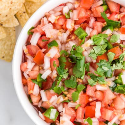 overhead view of homemade pico de gallo in white bowl.