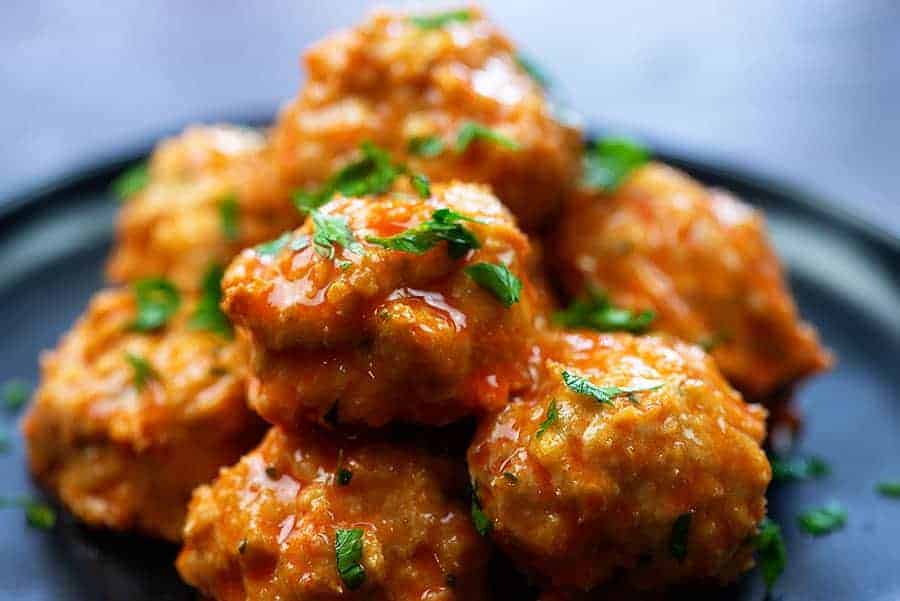 Close up view of low carb buffalo chicken meatballs on a plate.