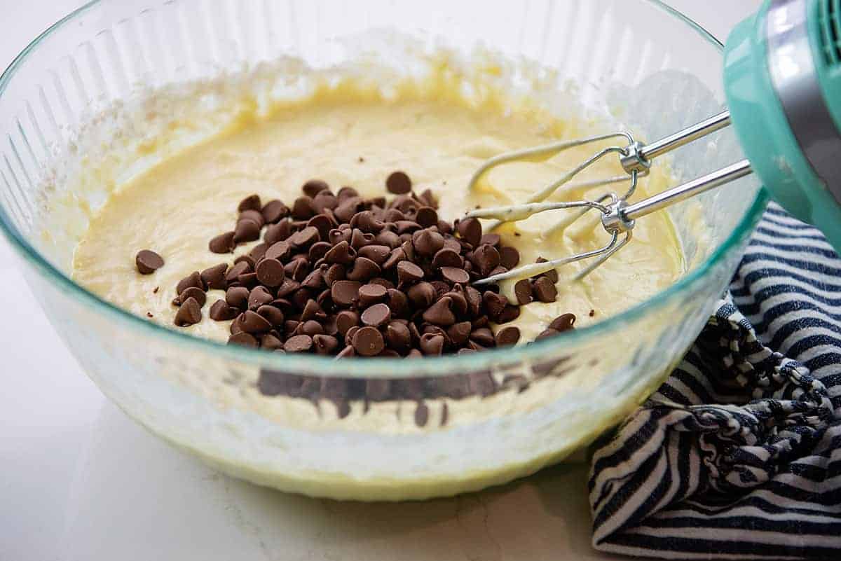 cinnamon roll cake batter in glass mixing bowl.