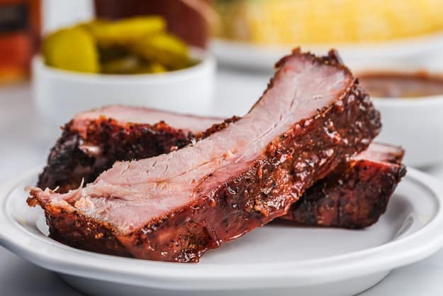 pile of ribs on white plate.