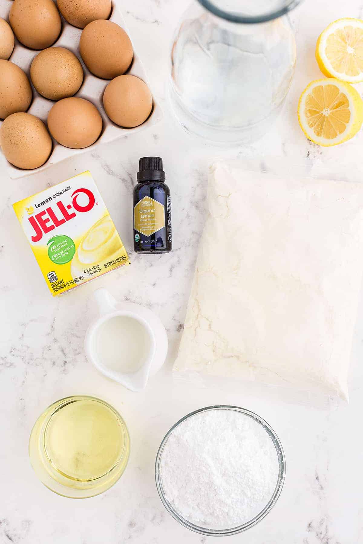 ingredients for lemon bundt cake on white background.