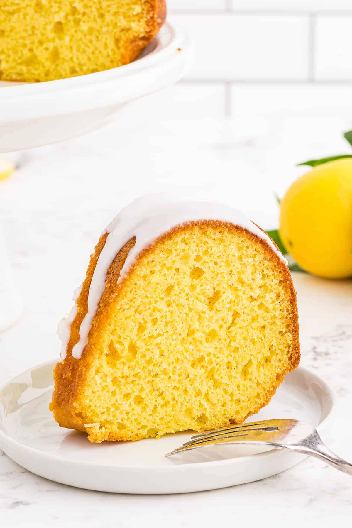 slice of lemon bundt cake on white plate.