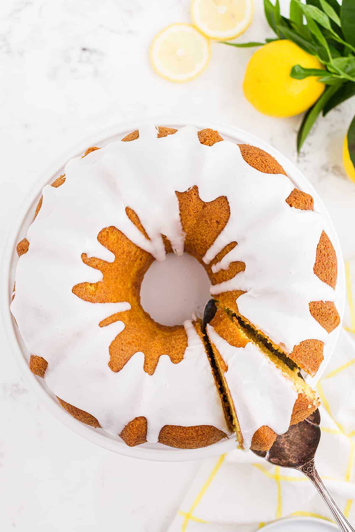 moist lemon bundt cake on cake stand.