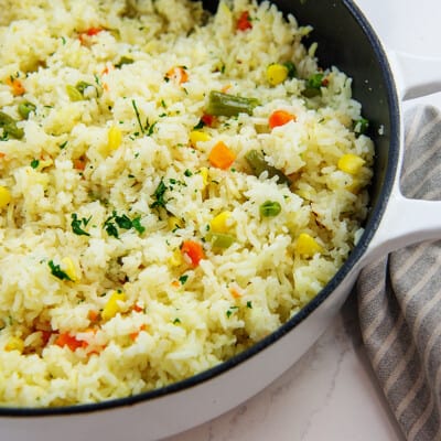 rice with vegetables in white pot.